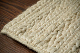 Ivory cream wool rug styled in a living room setting