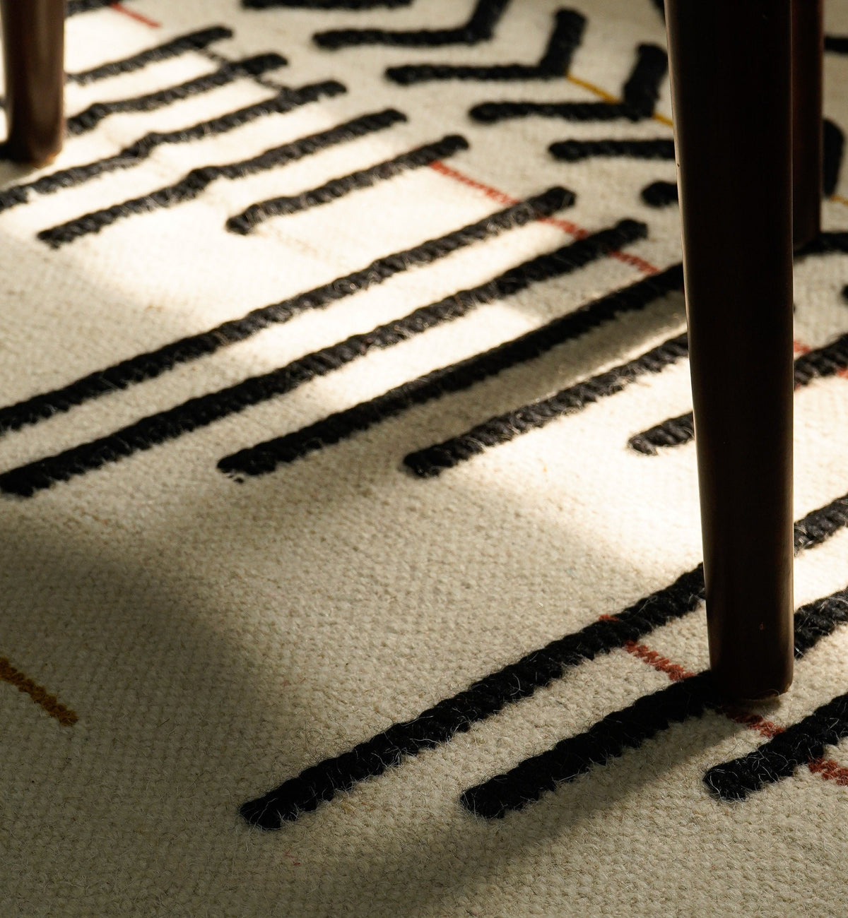 Ivory flatweave rug styled in a living room setting