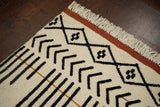 Ivory abstract rug styled with minimalist furniture