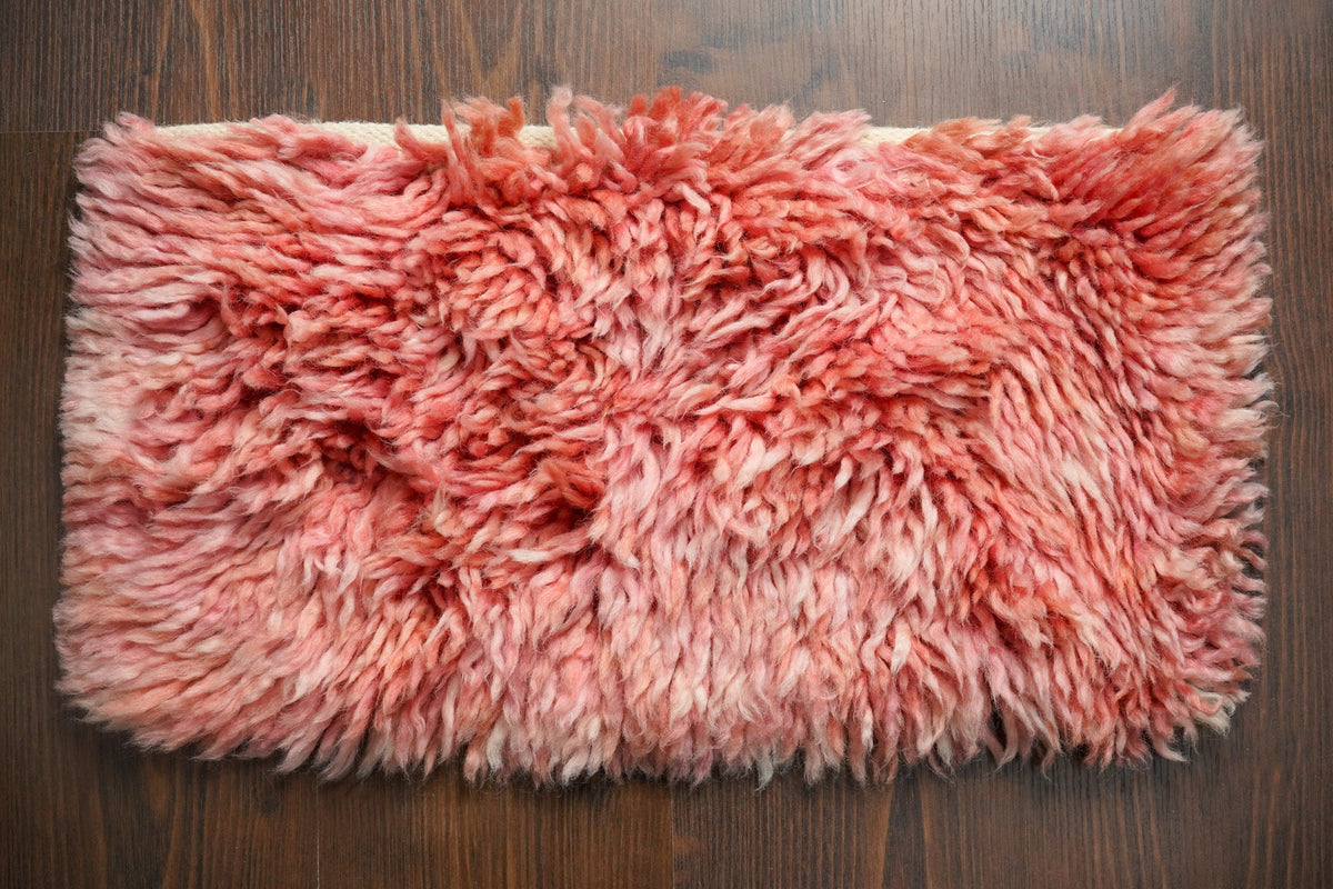 Pink shag wool rug full flat lay top view