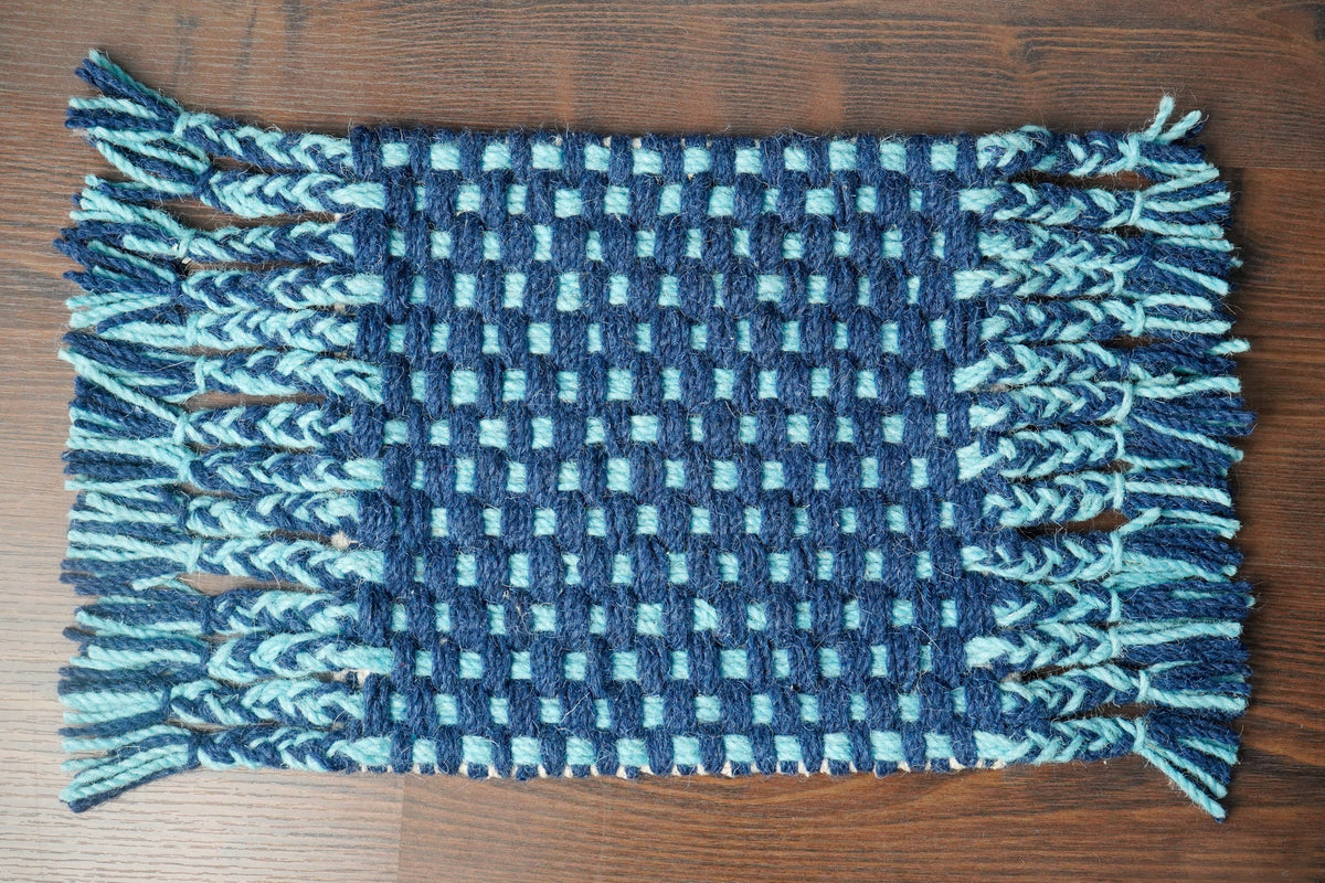 Blue wool rug styled near a neutral sofa