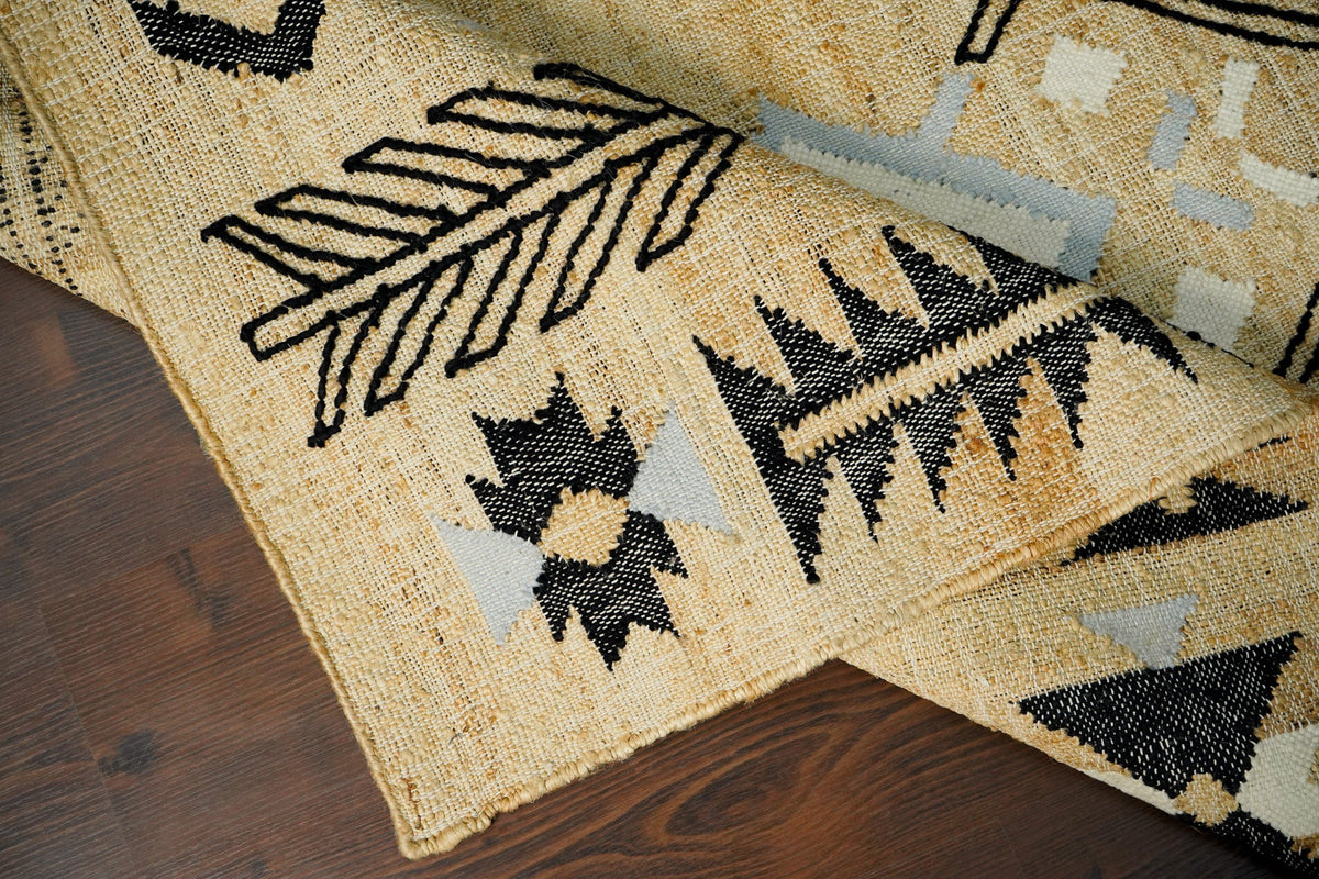 Jute rug texture close-up showing charcoal accent dots