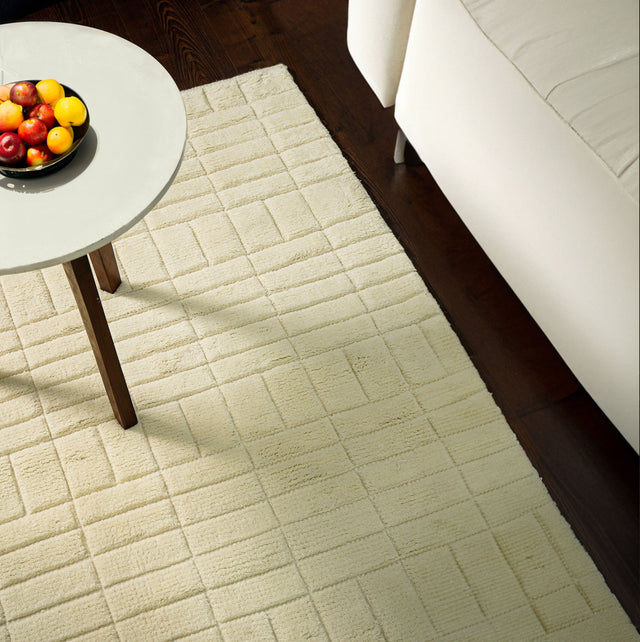Ivory geometric wool rug styled in a bright living room
