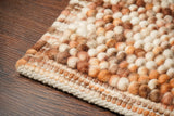 Brown wool rug pile texture close-up in natural light