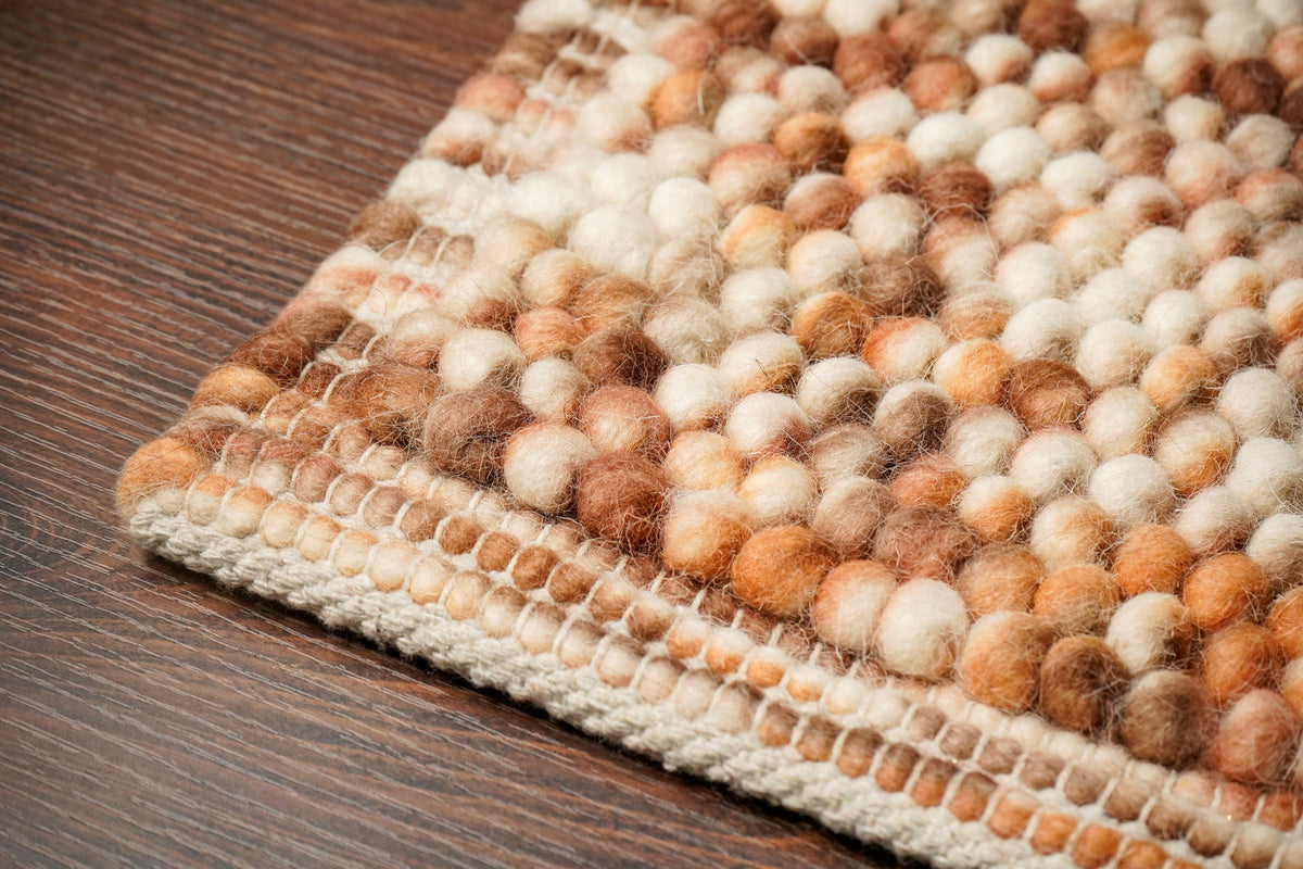 Brown wool rug pile texture close-up in natural light