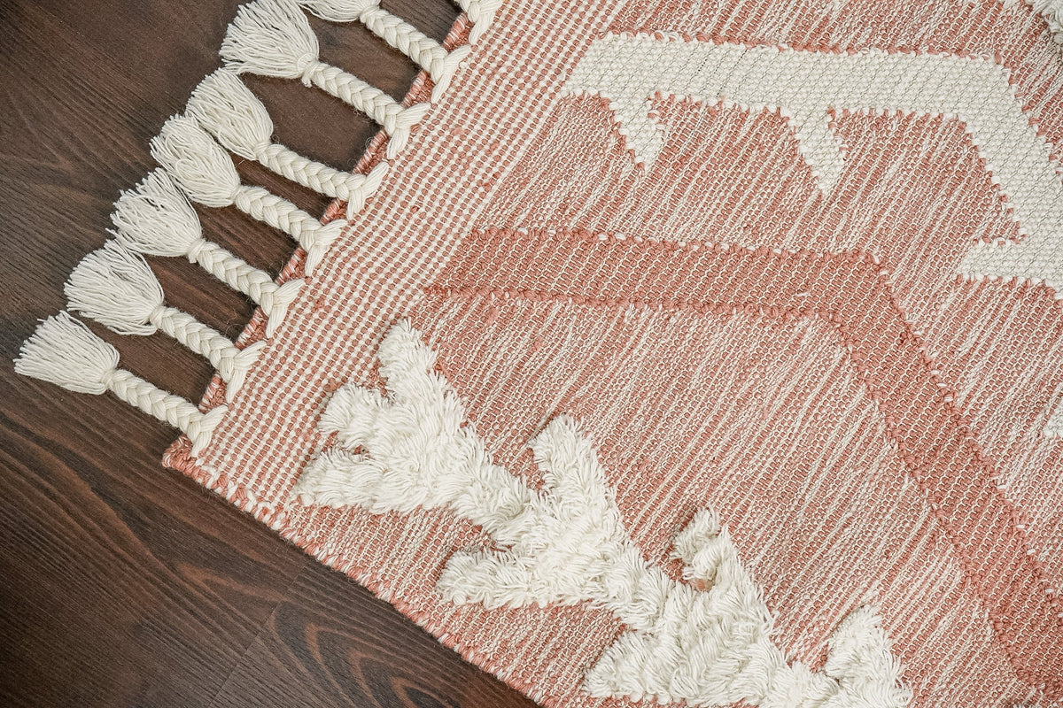 Pink rug styled in a nursery setting