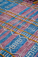 Handwoven kilim rug placed under living room furniture
