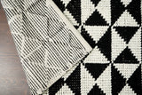 Checkered wool rug in a bedroom setting