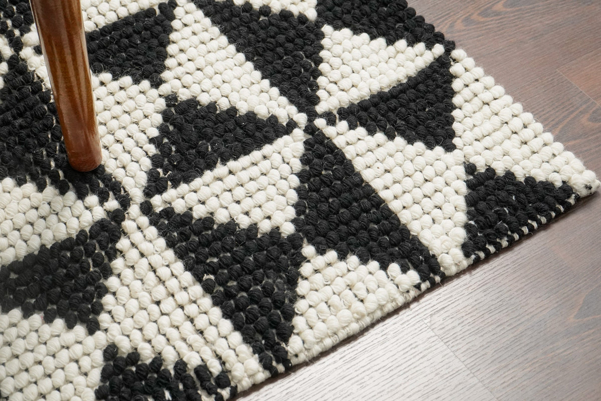 Checkered wool rug styled with furniture in room