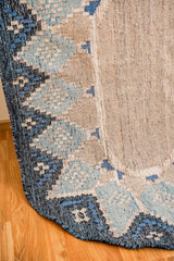 Blue oval rug in a bedroom setting