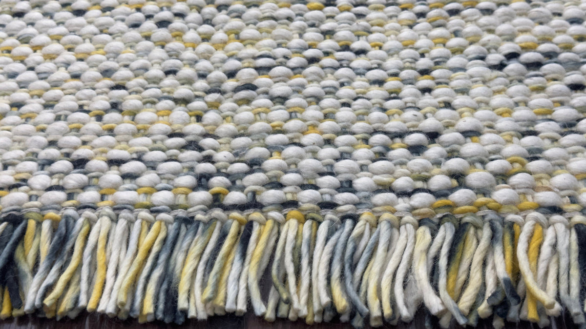 Wool rug corner view showing multi blend colors