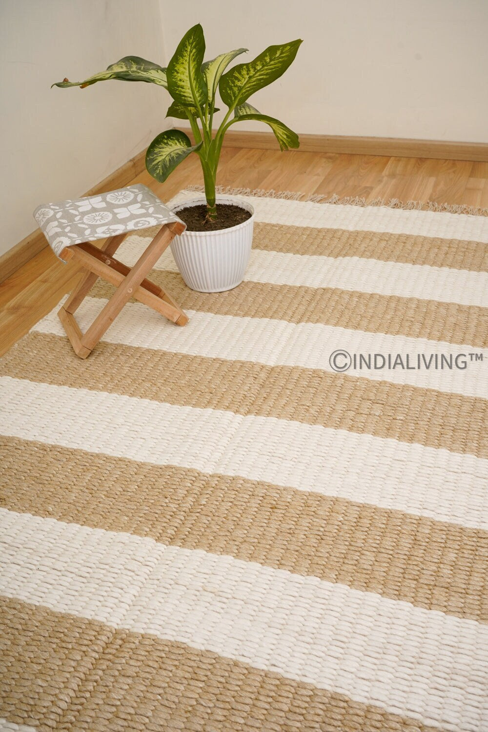 Ivory beige striped wool rug styled in a living room