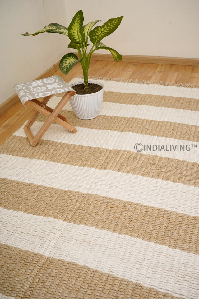 Ivory beige striped wool rug styled in a living room