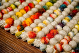 Striped wool rug styled in a nursery