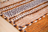 Close-up of cotton chenille weave on brown kilim rug