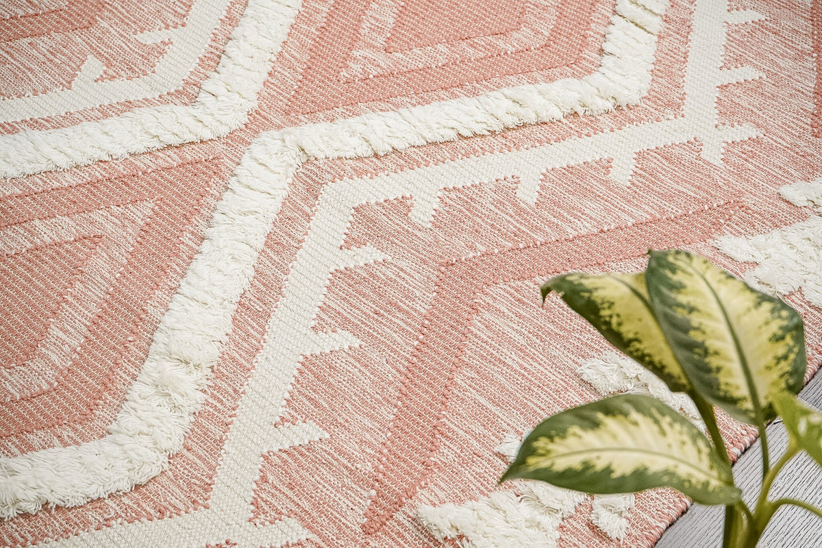 Pink rug styled in a living room