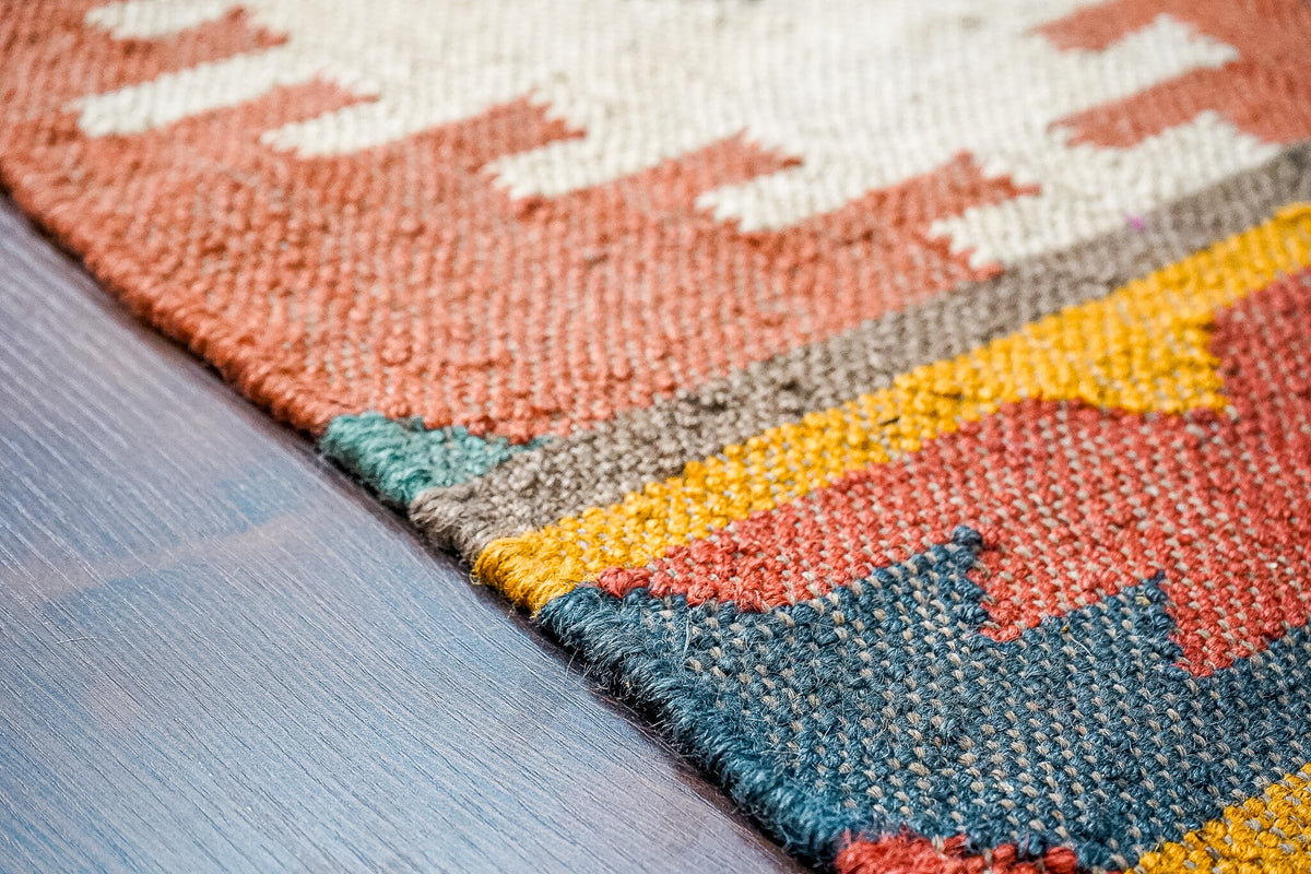 Wool jute kilim rug shown at an angle in room decor
