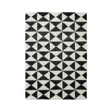 Checkered wool rug styled in a living room