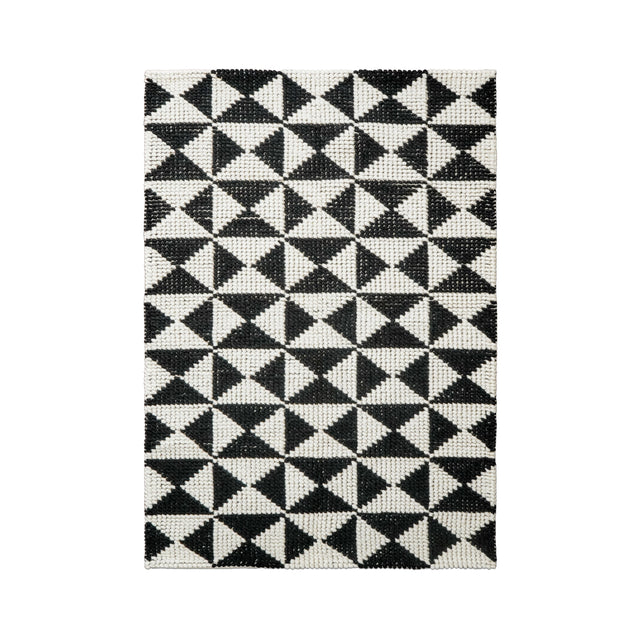 Checkered wool rug styled in a living room