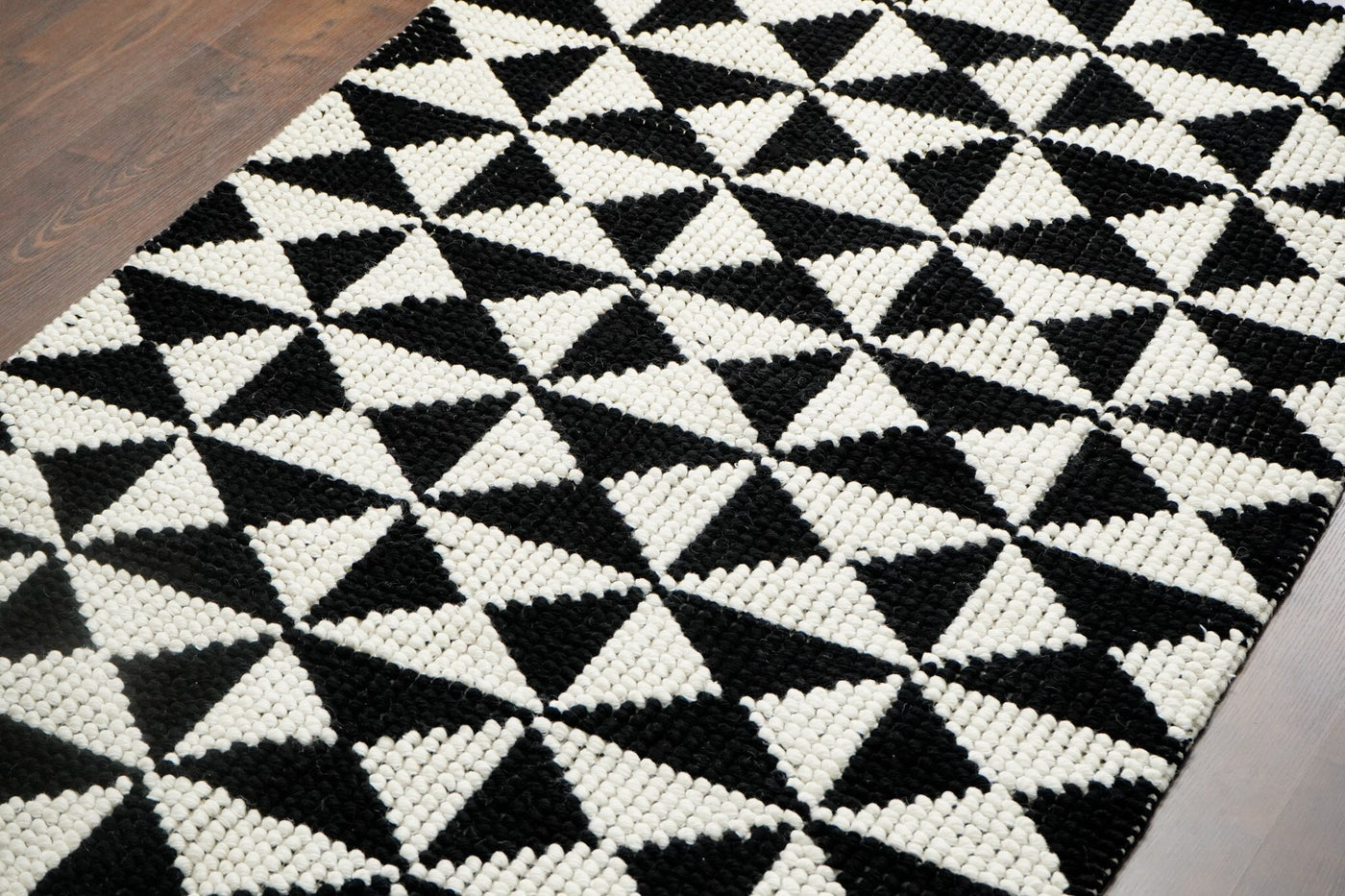 Black and white checkered wool rug, flat lay view
