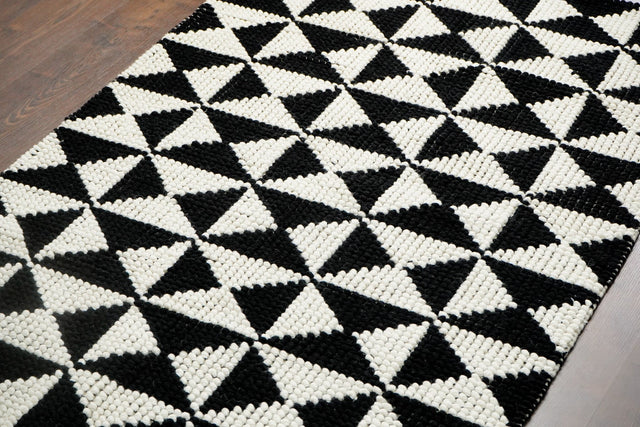 Black and white checkered wool rug, flat lay view
