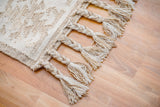 Close-up of handwoven texture on white kilim rug