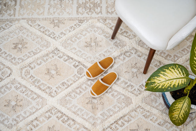 White kilim rug styled in a bright living room