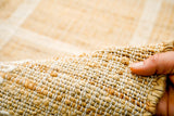 Jute area rug placed in a farmhouse-style bedroom