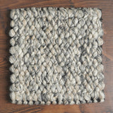 Wool loop rug texture close-up under natural light