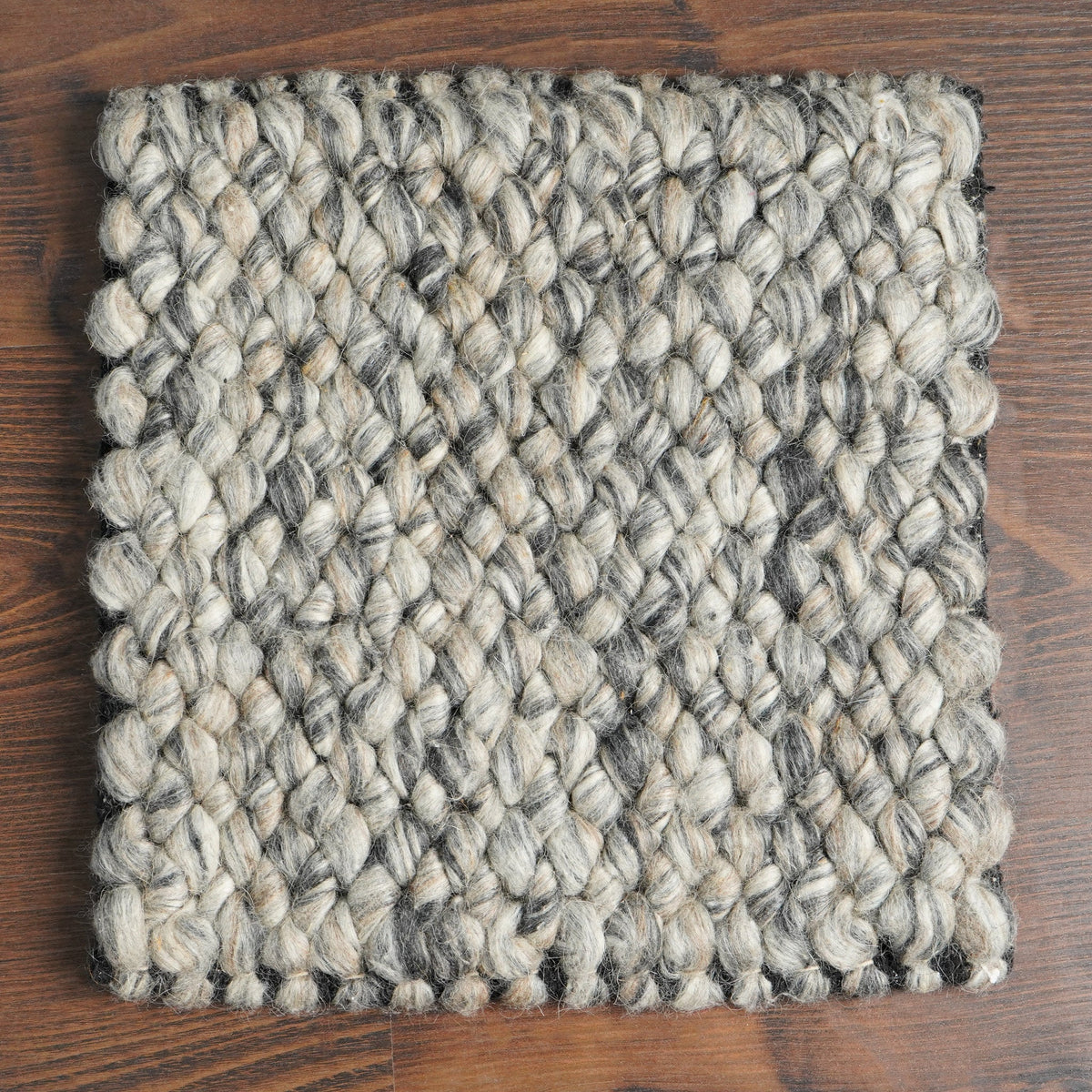 Wool loop rug texture close-up under natural light