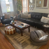 Grey beige rug styled in a living room