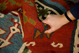 Red tribal aztec kilim rug in living room