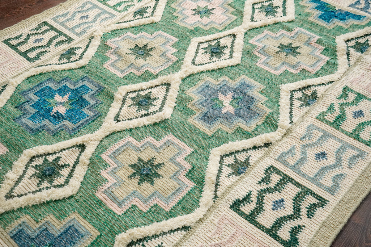 Green kilim rug under coffee table in living space