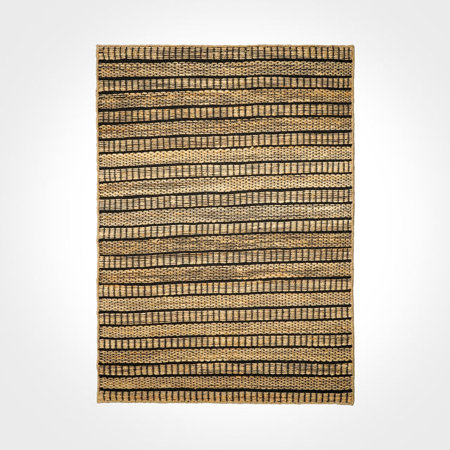 Ribbed jute rug styled in a living room