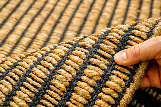 Black ribbed jute rug styled in a living room