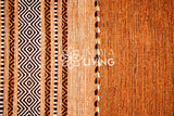 Brown kilim rug shown in a bedroom setting