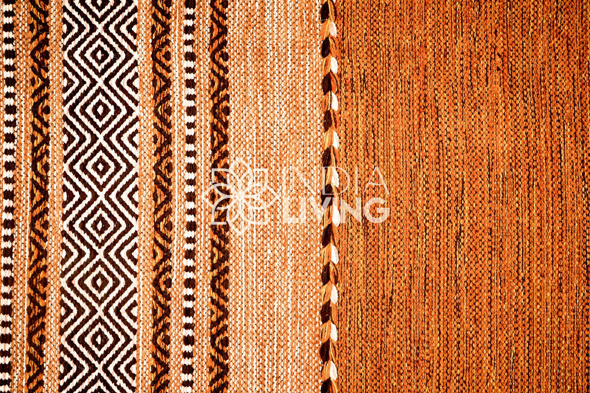 Brown kilim rug shown in a bedroom setting