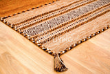 Overhead view of brown kilim rug