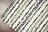 Grey and ivory chunky loop wool rug in bedroom setting