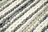 Grey and ivory chunky loop wool rug styled corner view