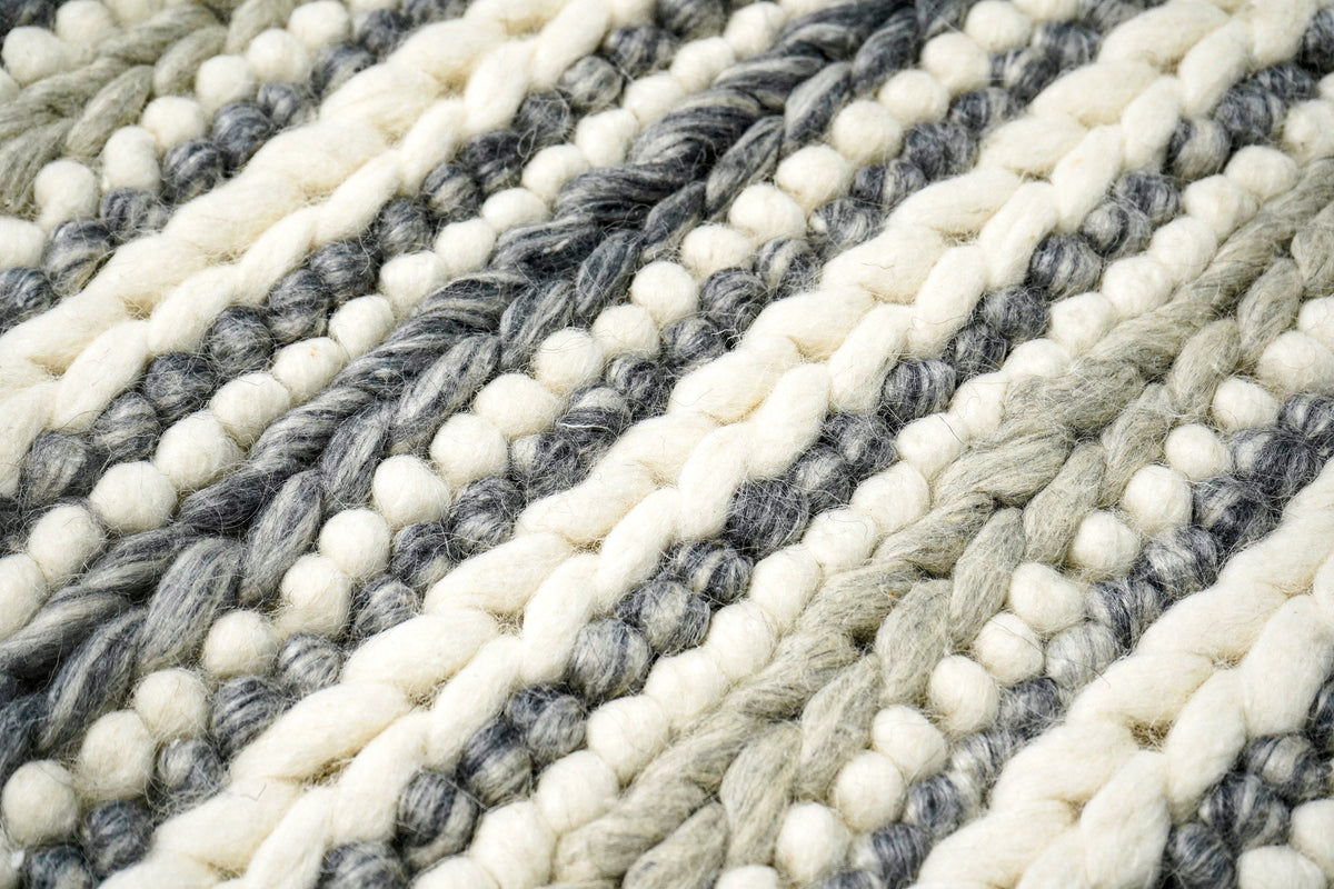 Grey and ivory chunky loop wool rug styled corner view