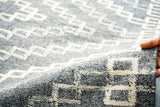 Fringe and braided edge detail of grey rug