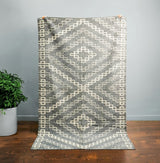 Grey abstract rug styled in a living room