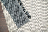 Grey wool rug in a bedroom setting
