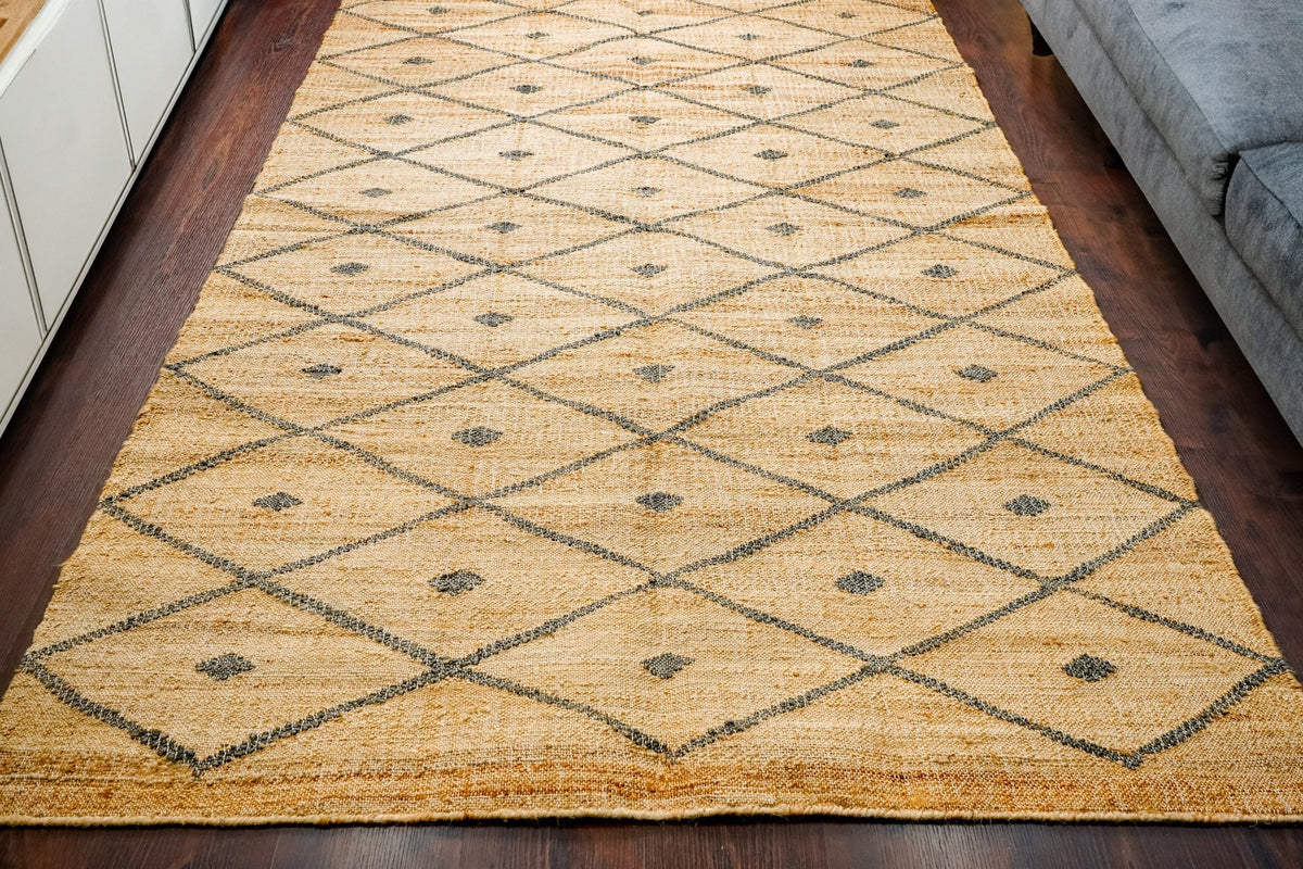 Corner detail of grey diamond jute rug