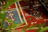 Red tribal aztec kilim rug pattern detail