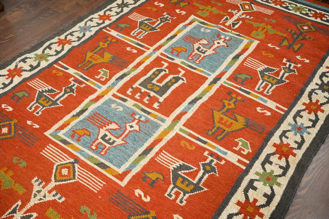 Red tribal aztec kilim rug, flat lay view