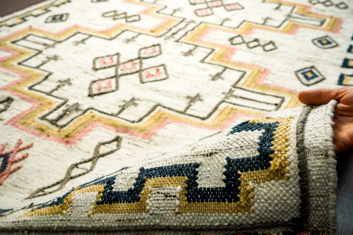Fringe and braided edge detail of ivory kilim rug