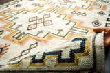 Fringe and braided edge detail of ivory kilim rug