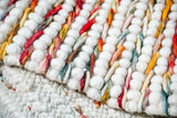 Colourful wool rug shown as sample swatch